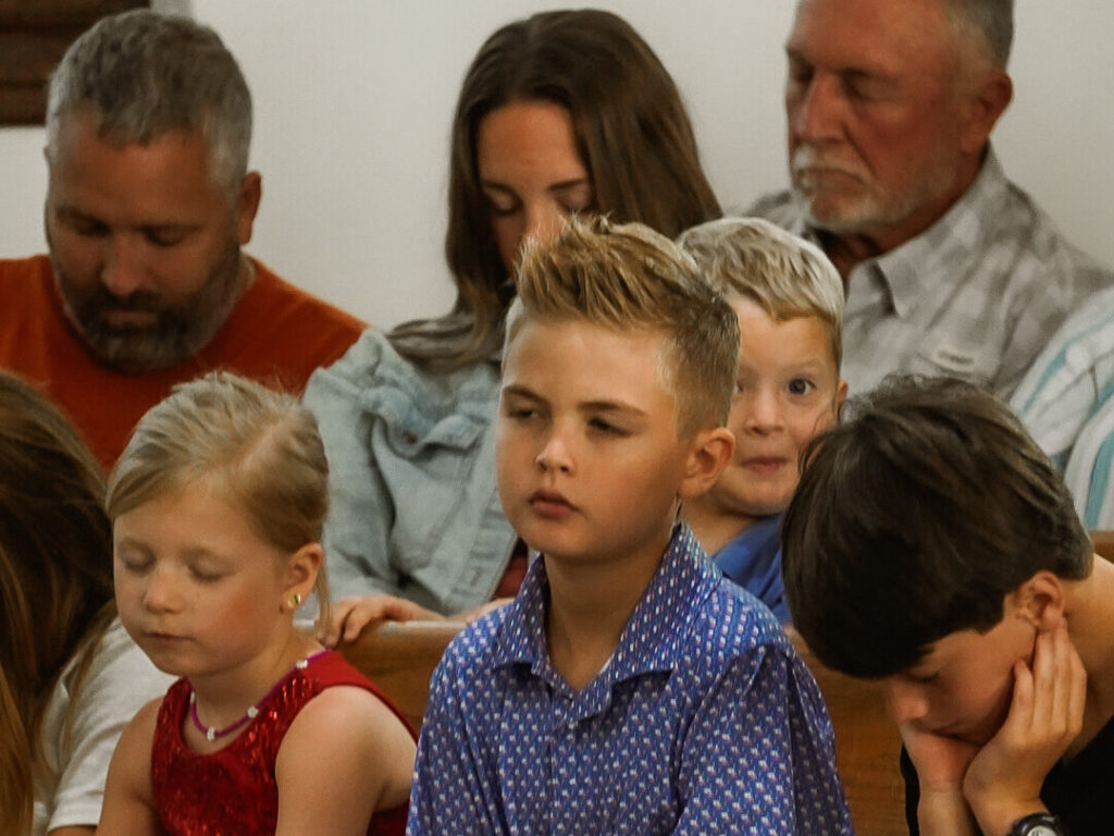 Sunday morning kids and adults praying